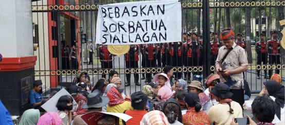 Demo vor hohem Zaun mit Banner "Sorbatua Siallagan freilassen"