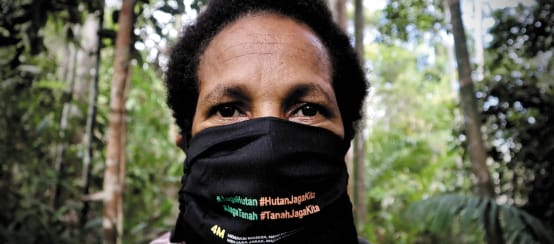Papua-Frau mit Mundschutz "Schütz den Wald - der Wald schützt uns"
