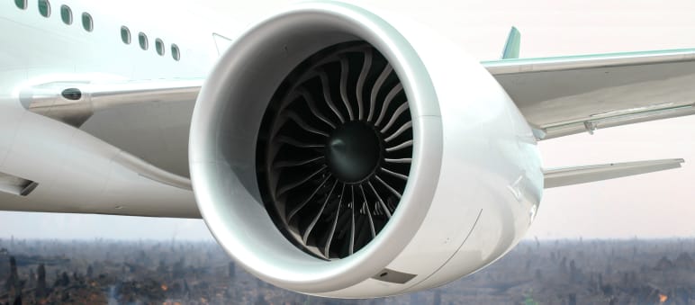 Irre Idee: Fliegen mit Palmöl Fotomontage: Turbine eines Düsenflugzeugs vor verbranntem Regenwald