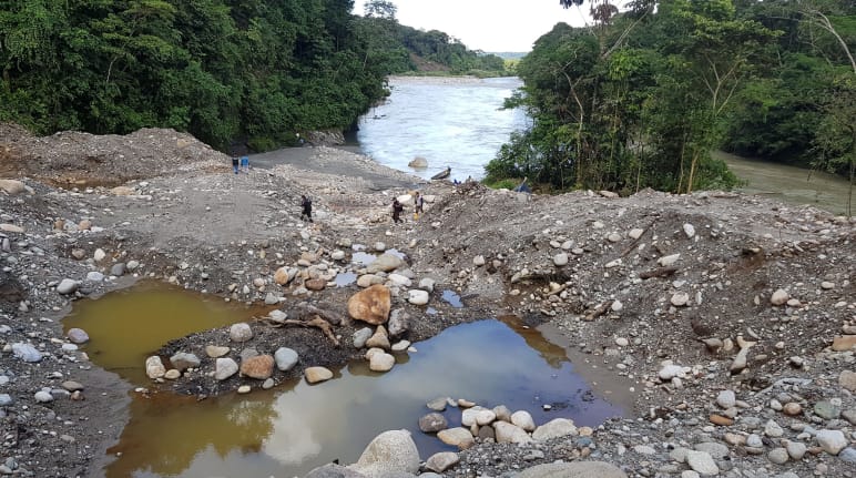 Durchwühlte Sedimente und verseuchte Teiche an einem Flussufer im Regenwald