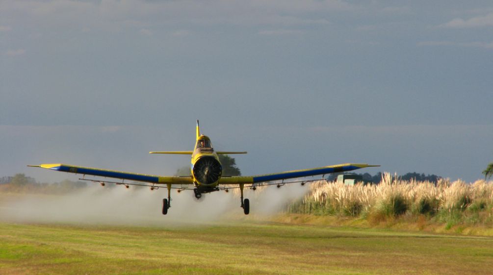 Flugzeug sprüht Glyphosat auf Acker